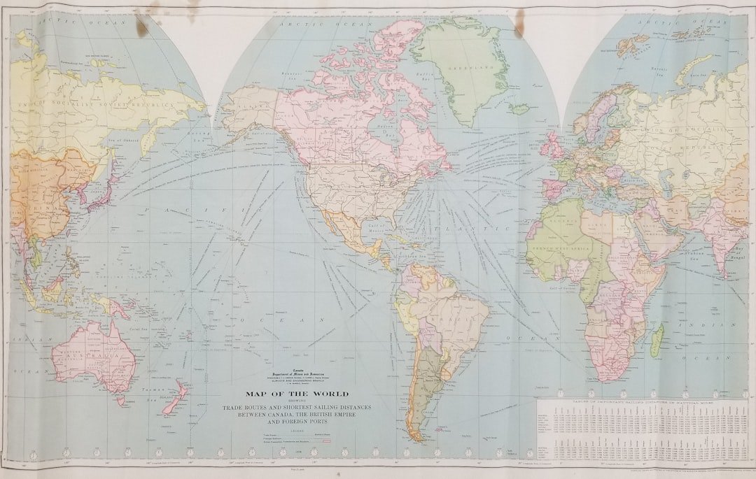 Person planning Caribbean citizenship by investment with laptop and world map
