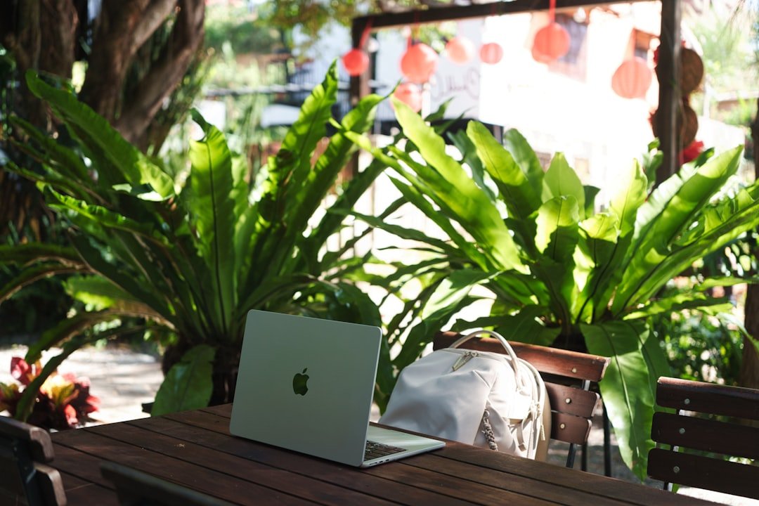 Digital nomad working on laptop at outdoor cafe in Medellin Colombia 2026
