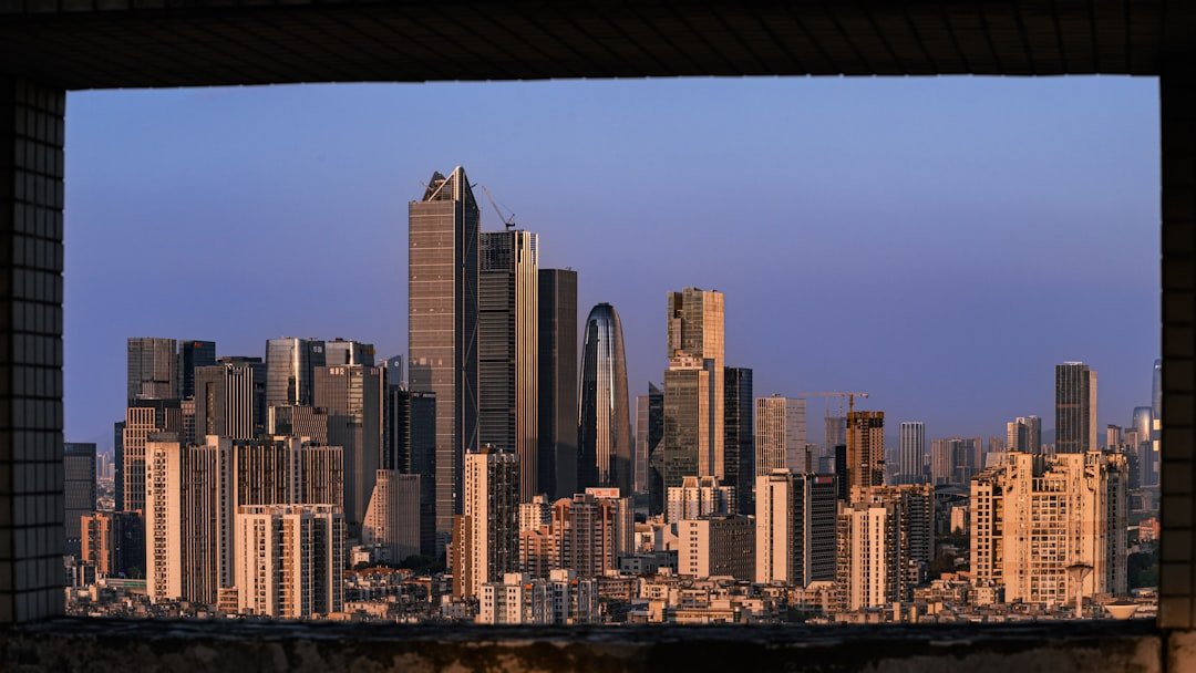 Modern skyline at dusk representing wealth inequality and real resource ownership