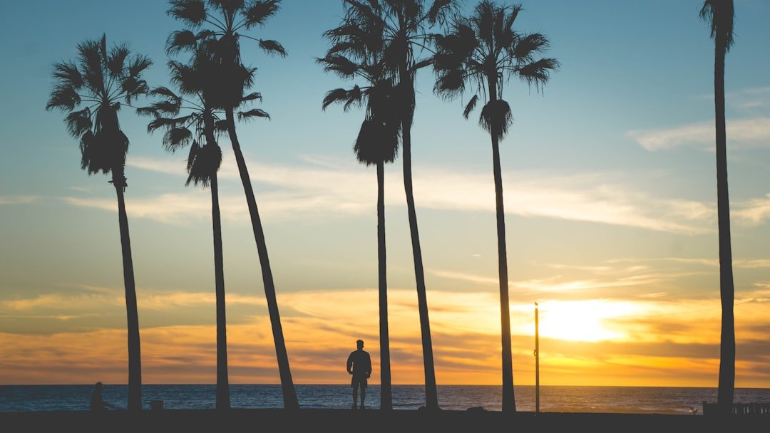 Couple walking along a Brazilian beach at sunset