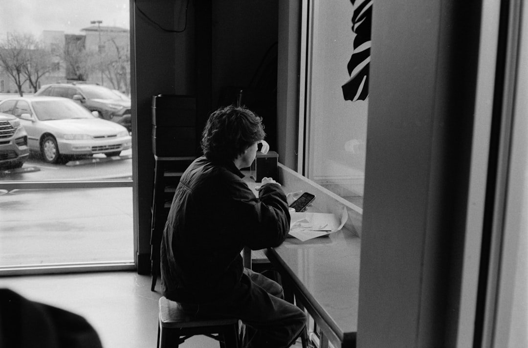 Expat life in Denmark - person sitting alone at a cafe window