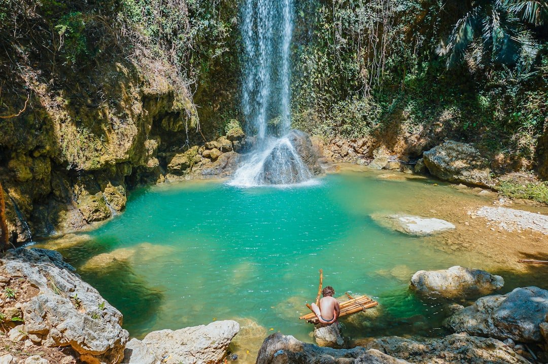 Yucatan cenote with turquoise water surrounded by jungle in Mexico